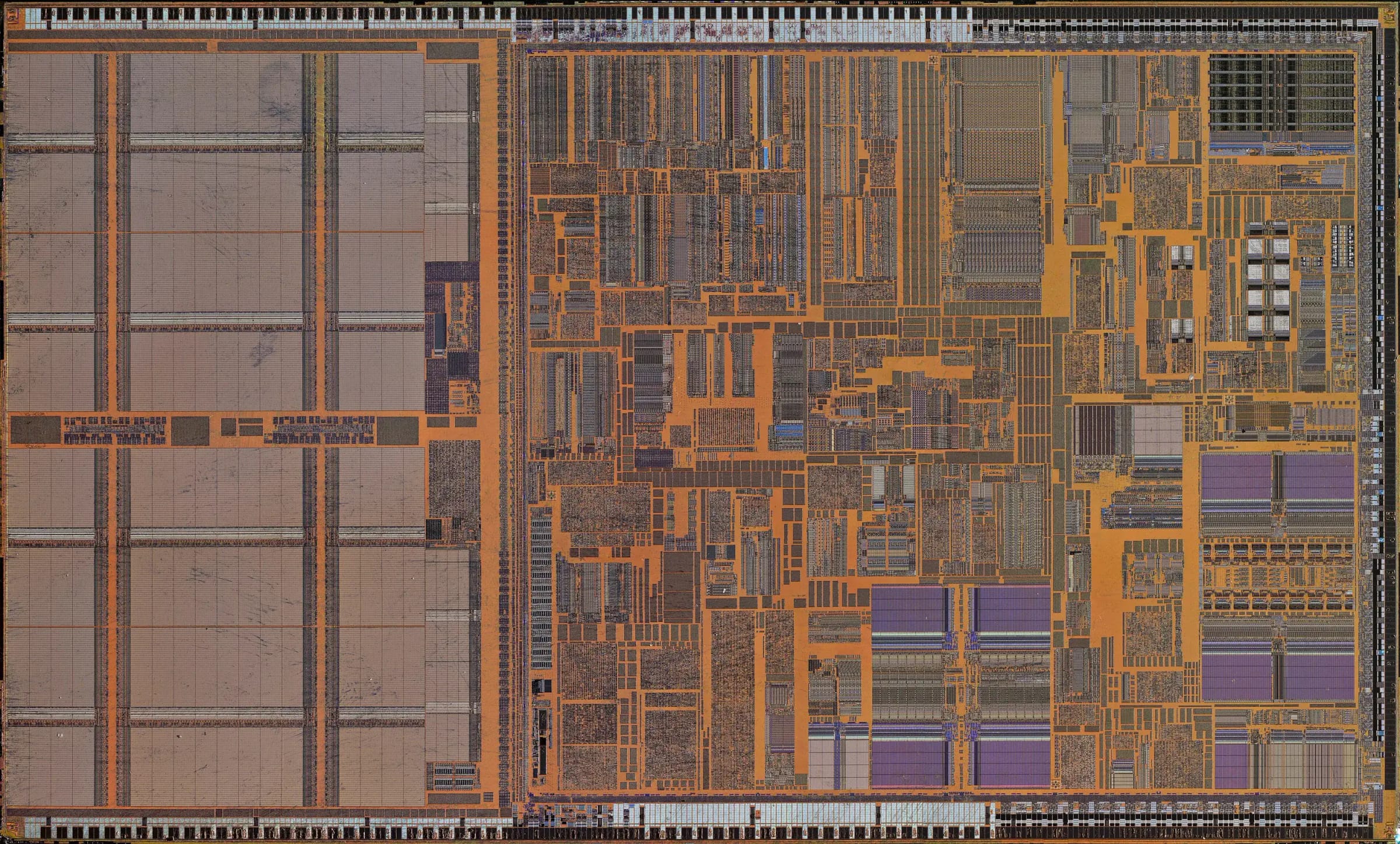 Magnified photo of a processor's silicon die, with orange wiring between grids of grey and purple circuit blocks